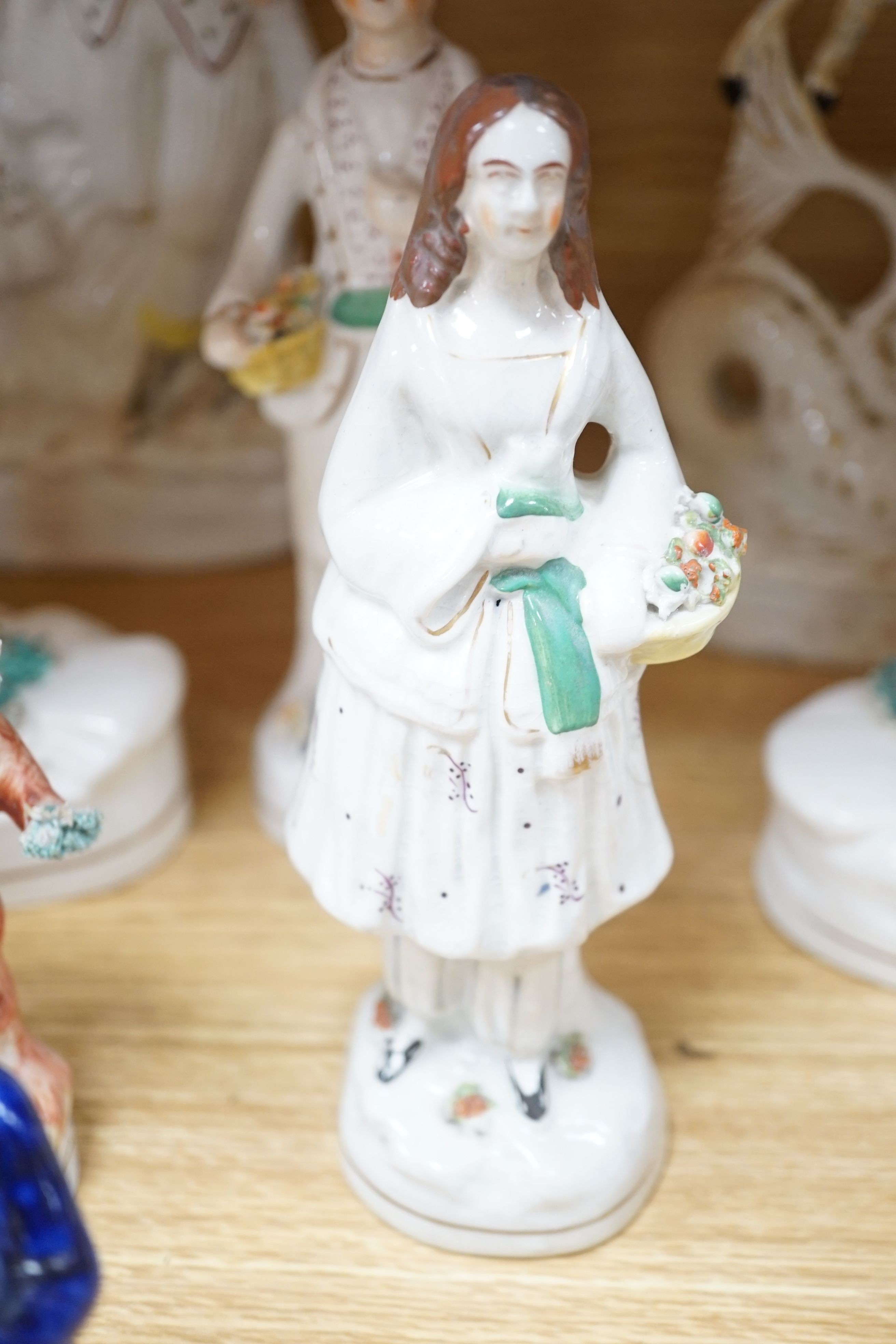 A collection of twelve Victorian Staffordshire flat back figures and groups, tallest 31 cms high.